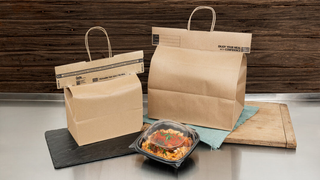 Two paper bags on a stainless steel table. Each bag is sealed with Handle Cuffs™ Tamper-Evident Bag Seals.